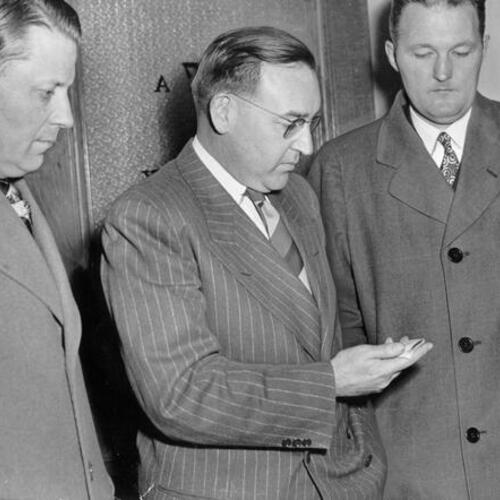 [District Attorney Edmund G. Brown (center) with Assistant District Attorneys Marshall Leahy (left) and Norman Elkington]