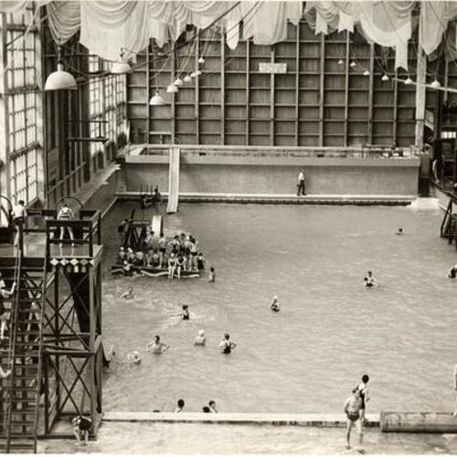[Group of people swimming at one of Sutro Baths pools]