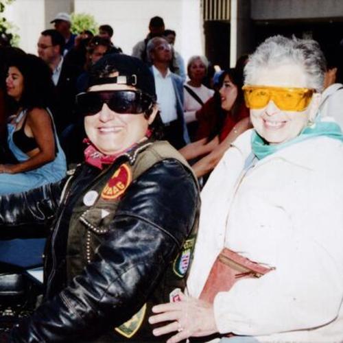 [Two women on motorcycle at Gay Pride Parade]