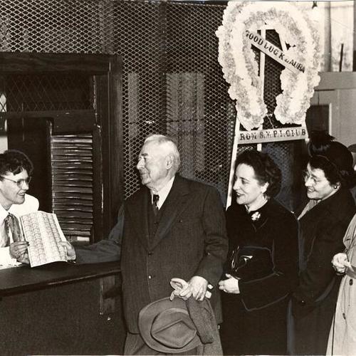 [Mrs. Laura Sunseri selling stamps to South Mission-Potrero Improvement Club (S.M.P.I.C.) president, A.J. Pratt, while Mrs. Theresa Ratto and Mrs. Isabelle Graves, assistant secretary-treasurer, wait their turns in the new Mission and Bryant Post Office]