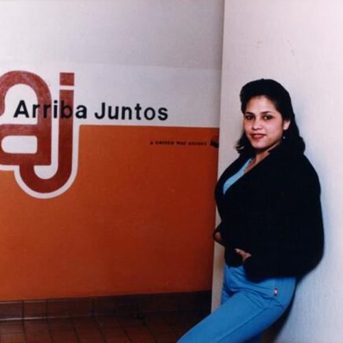[Woman standing at lobby of Arriba Juntos office]