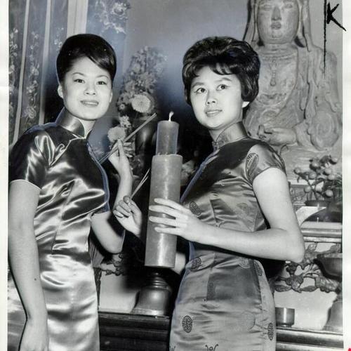 [Shari Louie and Soo Lee standing in front of a statue of the goddess Kuan Yin]