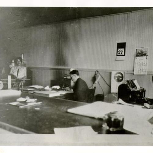 [Three people working in an office in Visitacion Valley]