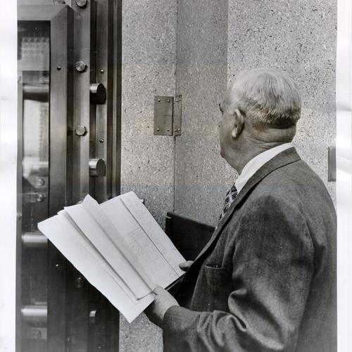 [Andrew R. Johnson inspecting the vault at Bank of America's San Francisco International Airport branch]