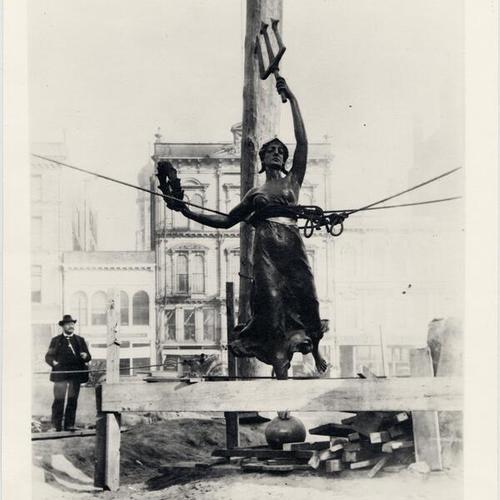 [Sculptor Robert Aitken looking at "Victory" statue before it was placed on top of the Dewey Monument]