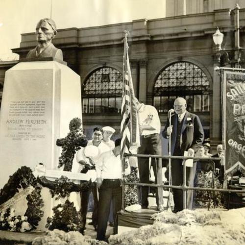 [Mayor Angelo Rossi unveiling a statue of the late labor leader Andrew Furuseth in front of the Ferry Building]