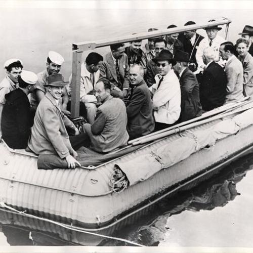 [Steel life raft shown with 20 men]