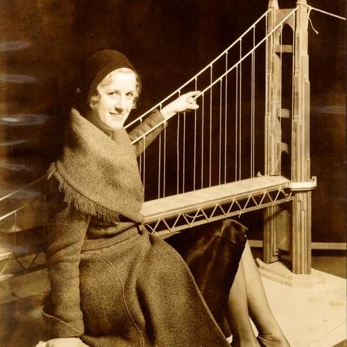 [Patricia Wilson displaying a miniature model of Golden Gate Bridge]