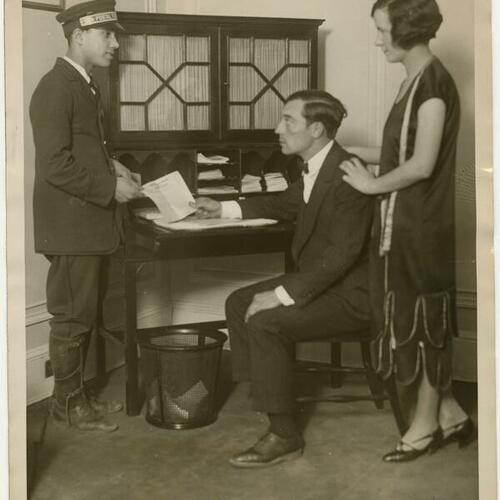 Buster Keaton and wife Natalie Talmadge receiving telegraph at Hotel Biltmore