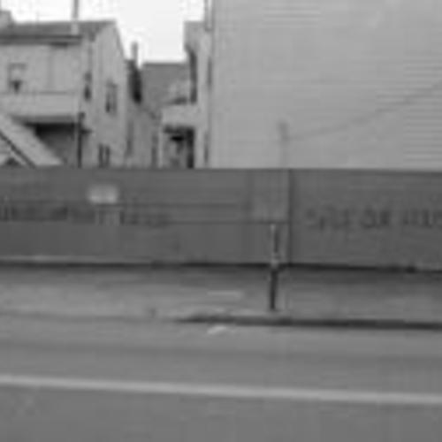 [Spray painted on wall, "Redevelopment kills, save our houses"]