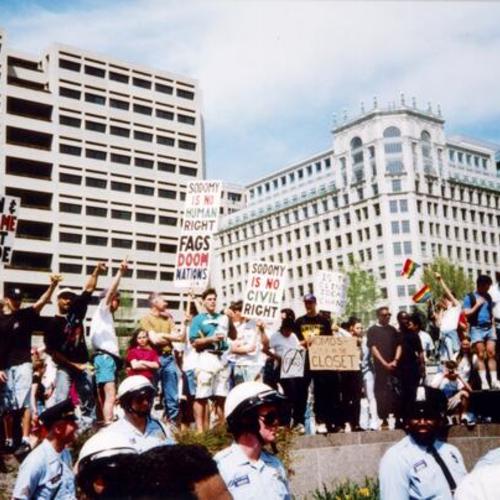 [Gay March in Washington with anti-gay demonstrators protected by police]