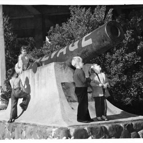 [Children playing on an old cannon at the Presidio]