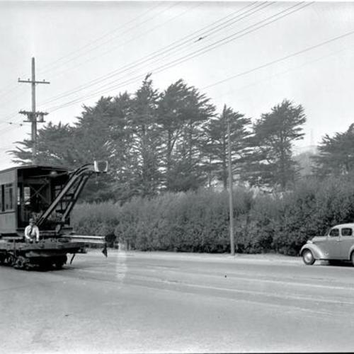 [Ocean avenue near San Jose looking west showing crane car #0130 operating from rear controller]