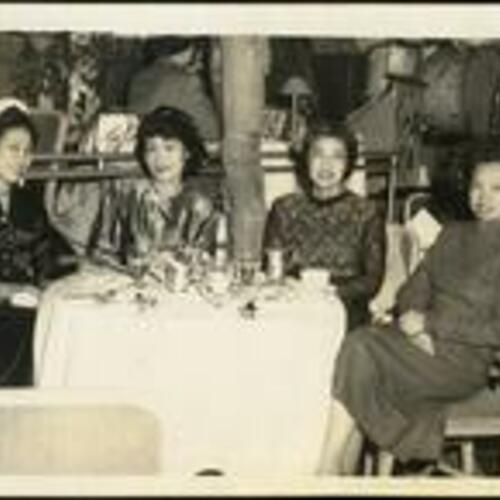 [Maxine Gonong seated at table with three other Filipina women at the St. Francis Hotel]