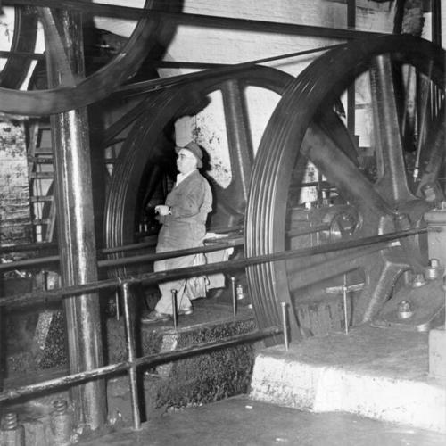 [J. P. Oliva working in the cable car powerhouse at Hyde and California streets]