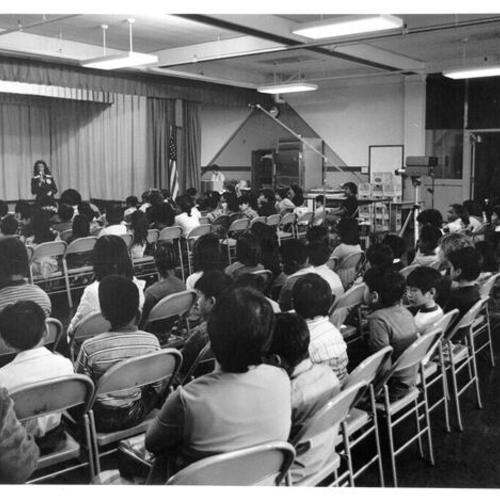 [Unidentified person speaking to an assembly of Washington Irving School students]