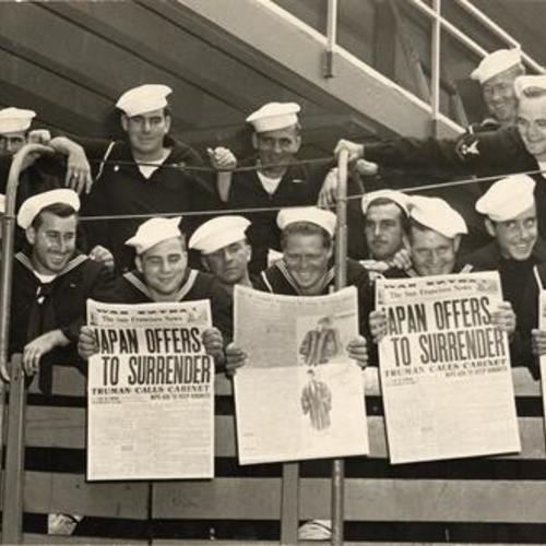 [Truck load of sailors displaying headlines of Tokyo's surrender]