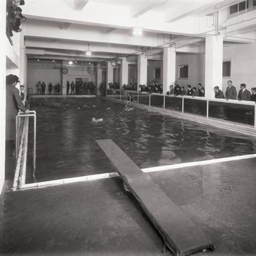 People watching and swimmers at Y. M. C. A. pool