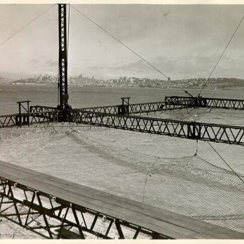 [View of safety net used to protect workers during construction of the Golden Gate Bridge]