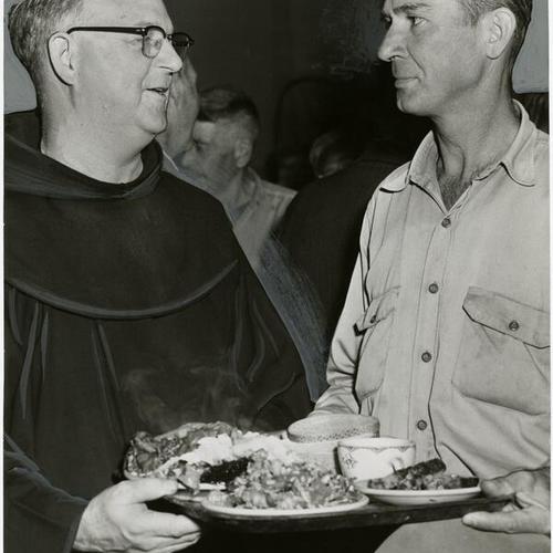 [Father Alfred Boeddeker serves the two millionth meal at St. Anthony's dining room]