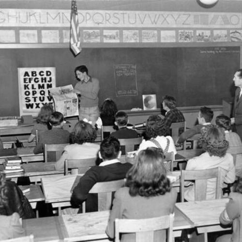 [Students seated in classroom at Denman Jr. High School]
