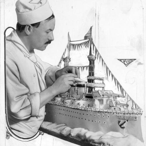 [Chef Maxine preparing a cake in the shape of a battleship]