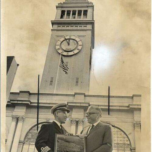[Captain T. Komabayashi of the freighter Muneshima Maru receiving an award from Cyril Magnin in front of the Ferry Building]