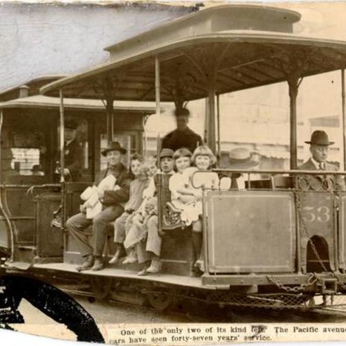 [People riding on a Pacific Avenue cable car]