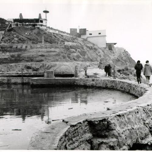 [Several people walking along the ruins of Sutro Baths]