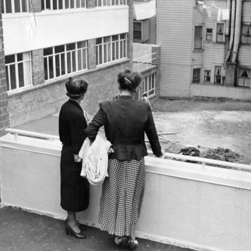 [Mrs. Bela V. Low-Beer and Mrs. Lewis F. Morrison overlooking a patio at the Florence Crittenton home]