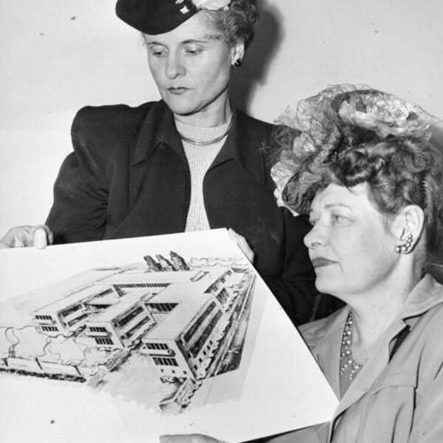 [Mrs. Lewis F. Morrison (left) and Mrs. Theodore G. Swanson examining a sketch of a proposed new building for the Florence Crittenton home]