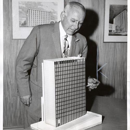 [Roy Buell displaying a model of proposed Pacific Telephone & Telegraph Company central office building]