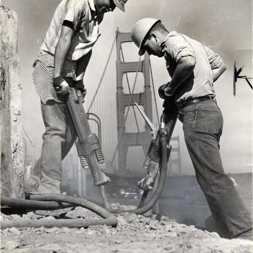 [Sammy Carlyle and Phil Gourley using jackhammers to widen gate approach]