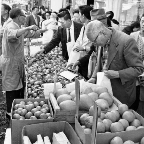 [Shoppers at a sidewalk grocery stand in Chinatown]