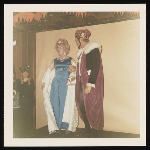 Portrait of two people in costume on stage at Halloween party