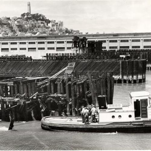 [Tugboat Gov. Stephens pulling debris out of the channel leading to the Southern Pacific pier at the Ferry Building after an accident involving a ferryboat]