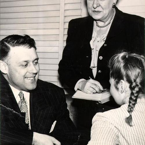[George Ososke, chief county probation officer, and Miss Margaret Daily, of the Juvenile Court's girls division, with an unidentified teenage girl]