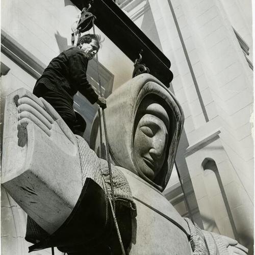 [Sculptor Beniamino Bufano helping workers move his statue of Saint Francis of Assisi from the entrance of the St. Francis of Assisi Church to a temporary location on Oakland]