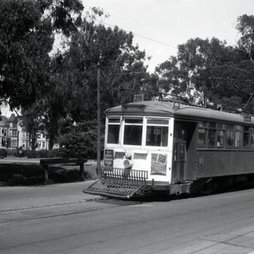 [Oak near Ashbury street looking northeast at outbound #20 line car 295 along Panhandle]
