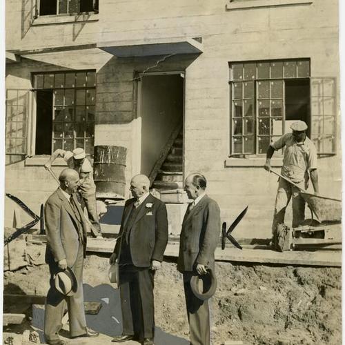 [Portrait of Dr. J.C. Geiger, Mayor Rossi and Albert J. Evers. Workman in background]