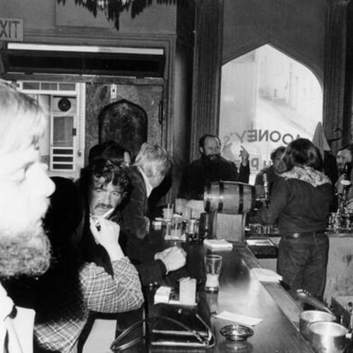 [Customers mingling at Mooney's bar located on Grant Street]