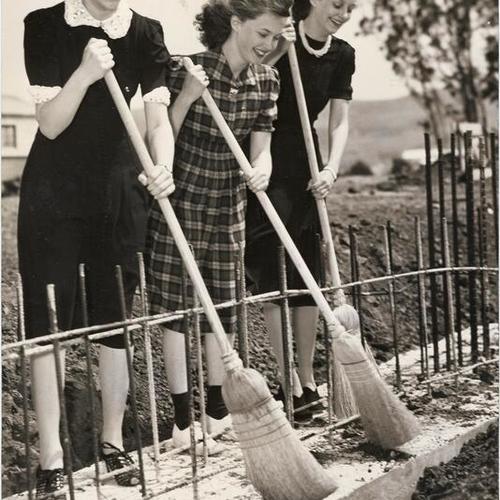[San Francisco Junior College students Dorothy Trood, Muriel Nolan and Janet Ball sweeping off foundation of new Science Building]