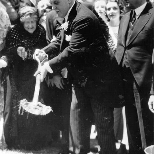 [California Governor James Rolph turns the first shovel full of dirt at Bay Bridge ground-breaking ceremony]