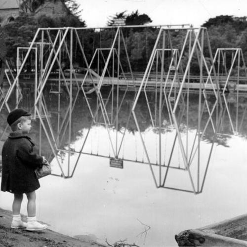 [Child looks at the flooded Childrens' Playground in Golden Gate Park]
