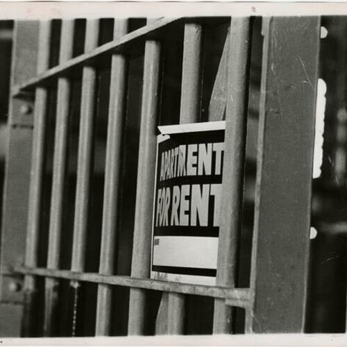 Apartment for rent sign on prison bars