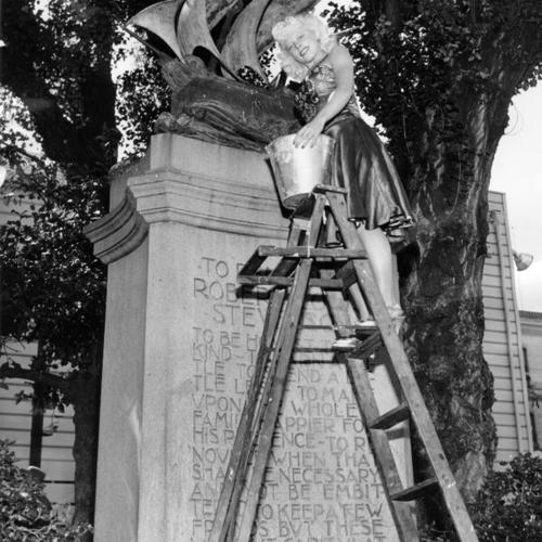 [Dolores Gonzales polishing the Robert Louis Stevenson monument]