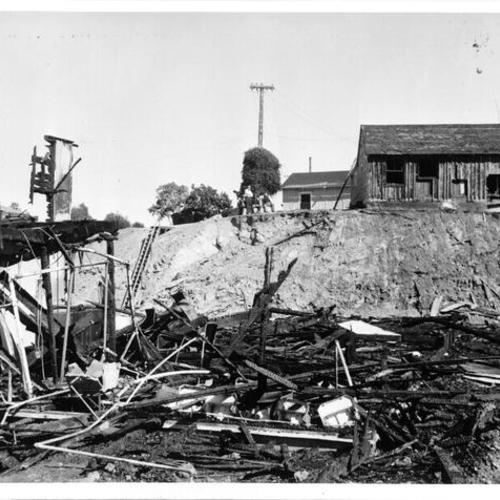 [Fire examiners view wreckage of barracks building after Angel Island blaze]