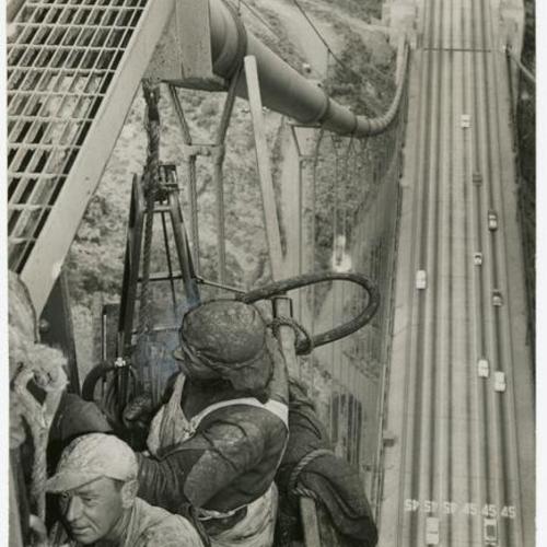 [Workers, Owen Ditmore and Lyle Phillips, working on the Golden Gate Bridge tower]