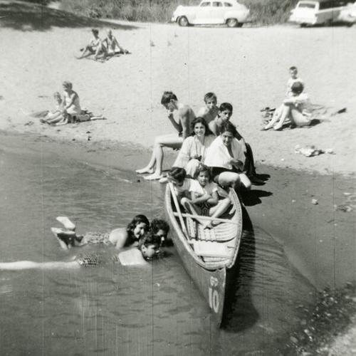 [Family gathering at Russian River with a canoe]