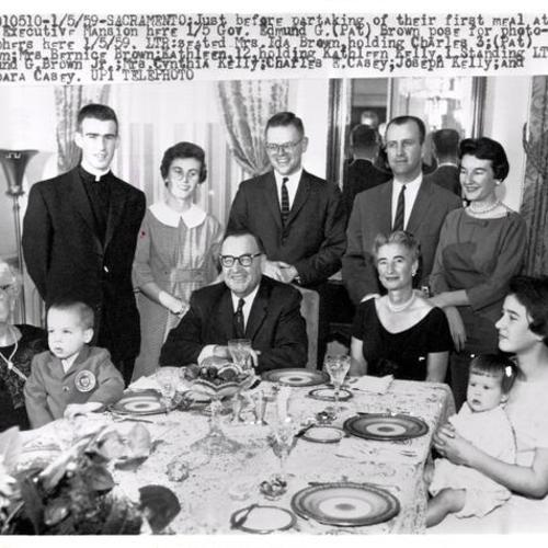 [Edmund G. Brown posing with his family before partaking of their first meal at the Executive Mansion]